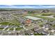 Beautiful aerial view of a home and neighborhood featuring a pond and well-manicured lawns at 32136 Conchshell Sail St, Wesley Chapel, FL 33545