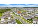 Aerial view showcases this home's prime location within a meticulously planned community with nearby lake at 32136 Conchshell Sail St, Wesley Chapel, FL 33545