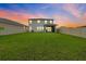 Spacious backyard featuring a large grassy area and a screened in porch at 32136 Conchshell Sail St, Wesley Chapel, FL 33545