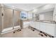 Bathroom featuring dual vanity, granite counters, shower with glass door, and a soaking tub at 32136 Conchshell Sail St, Wesley Chapel, FL 33545