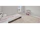 This bedroom offers natural light, neutral walls, carpeted floors, and a doll house and bed at 32136 Conchshell Sail St, Wesley Chapel, FL 33545