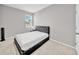 Bedroom featuring neutral carpet and a black upholstered bed at 32136 Conchshell Sail St, Wesley Chapel, FL 33545