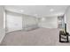 Large bonus room with neutral carpet, recessed lighting, and a modern sofa at 32136 Conchshell Sail St, Wesley Chapel, FL 33545