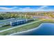 Scenic entrance featuring an 'Epperson' fountain and lush landscaping, adjacent to a tranquil lake at 32136 Conchshell Sail St, Wesley Chapel, FL 33545