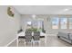Elegant dining area with a modern chandelier, stylish furniture, and a view of the backyard at 32136 Conchshell Sail St, Wesley Chapel, FL 33545