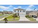 Two-story home with a well-maintained lawn, landscaping, and an attached two-car garage at 32136 Conchshell Sail St, Wesley Chapel, FL 33545