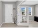 Bright foyer featuring tiled floors and glass paneled french doors to office at 32136 Conchshell Sail St, Wesley Chapel, FL 33545