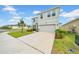 Attractive two-story home with a long driveway, two-car garage and manicured lawn at 32136 Conchshell Sail St, Wesley Chapel, FL 33545