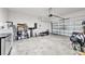 Spacious garage with white walls, concrete flooring, and storage shelves at 32136 Conchshell Sail St, Wesley Chapel, FL 33545