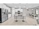 Well-lit kitchen with granite countertops, island with seating, stainless steel appliances, and ample storage at 32136 Conchshell Sail St, Wesley Chapel, FL 33545