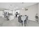 Bright eat-in kitchen with gray tile flooring, white cabinetry, granite countertops, and stainless steel appliances at 32136 Conchshell Sail St, Wesley Chapel, FL 33545