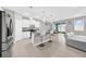 Modern kitchen features a center island with bar seating, stainless steel appliances, and an adjacent dining area at 32136 Conchshell Sail St, Wesley Chapel, FL 33545