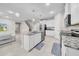 Stylish kitchen featuring an island with a sink, granite countertops, stainless steel appliances, and modern lighting at 32136 Conchshell Sail St, Wesley Chapel, FL 33545