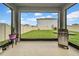 Outdoor lanai with barbecue grill and view of a spacious, fenced yard at 32136 Conchshell Sail St, Wesley Chapel, FL 33545