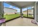Screened lanai with grill overlooking a well-maintained backyard and lawn at 32136 Conchshell Sail St, Wesley Chapel, FL 33545