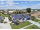 Aerial view of a single-story home with a manicured lawn and screened in pool at 325 Gladstone Blvd, Englewood, FL 34223