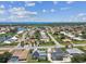 Wide aerial view showcasing neighborhood homes near a canal, close to the ocean at 325 Gladstone Blvd, Englewood, FL 34223