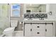 Bright bathroom with toilet and double vanity with backsplash at 325 Gladstone Blvd, Englewood, FL 34223