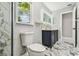 Modern bathroom featuring a blue vanity, marble floors, and shower at 325 Gladstone Blvd, Englewood, FL 34223