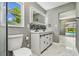 Bright bathroom with toilet, and double vanity with mirror at 325 Gladstone Blvd, Englewood, FL 34223