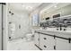 Bright bathroom with glass shower and double vanity with backsplash at 325 Gladstone Blvd, Englewood, FL 34223