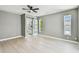 Bright bedroom with fan, and view to bathroom with sliding glass door at 325 Gladstone Blvd, Englewood, FL 34223