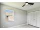 Bedroom with a ceiling fan and a closet with white doors at 325 Gladstone Blvd, Englewood, FL 34223