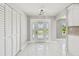 Welcoming entryway with decorative glass front door, white tile flooring, and closet storage at 325 Gladstone Blvd, Englewood, FL 34223