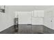 Spacious garage featuring epoxy flooring, storage cabinets, and utility connections at 325 Gladstone Blvd, Englewood, FL 34223