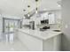 Bright kitchen with white cabinets, quartz counters, stainless steel appliances, and island at 325 Gladstone Blvd, Englewood, FL 34223