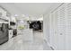 Updated kitchen and large living space with quartz countertops, modern backsplash, and stainless steel appliances at 325 Gladstone Blvd, Englewood, FL 34223