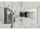 Bright kitchen featuring white cabinets, stainless steel appliances, and a large island at 325 Gladstone Blvd, Englewood, FL 34223
