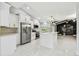 Bright, open kitchen featuring white cabinets, stainless steel appliances, and an island at 325 Gladstone Blvd, Englewood, FL 34223