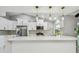 Bright kitchen featuring white cabinets, stainless steel appliances, and a spacious island at 325 Gladstone Blvd, Englewood, FL 34223