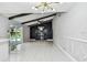 Bright living room with vaulted ceilings, backyard pool access, fireplace, and adjacent kitchen at 325 Gladstone Blvd, Englewood, FL 34223