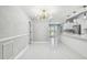 Living room features stylish lighting, modern wainscoting, open layout, and seamless flow to the updated kitchen at 325 Gladstone Blvd, Englewood, FL 34223