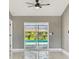Bright living room with fan, and glass sliding doors with pool view at 325 Gladstone Blvd, Englewood, FL 34223
