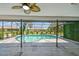 Relaxing pool area with screens for privacy, ideal for cooling off on a hot day at 325 Gladstone Blvd, Englewood, FL 34223