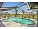 Private screened-in pool surrounded by lush landscaping, creating a serene oasis at 325 Gladstone Blvd, Englewood, FL 34223