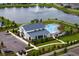 Aerial view of a neighborhood community, showcasing a pool, lake, and recreational area at 3559 Maple Bay Ln, Land O Lakes, FL 34638