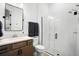 Bright bathroom featuring a glass shower, modern fixtures, and stylish vanity with a beautiful mirror at 3559 Maple Bay Ln, Land O Lakes, FL 34638
