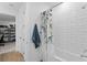 Bright bathroom featuring a tiled shower, floral curtain, and towel rack at 3559 Maple Bay Ln, Land O Lakes, FL 34638