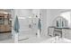 Elegant bathroom featuring a glass enclosed shower, a vanity and an oversized mirror for getting ready at 3559 Maple Bay Ln, Land O Lakes, FL 34638