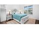 Sunlit bedroom featuring a beautifully decorated bed, a plush rug, and a large window at 3559 Maple Bay Ln, Land O Lakes, FL 34638