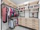 Well-organized closet with hanging clothes, drawers, shelves, and boxes to provide storage space at 3559 Maple Bay Ln, Land O Lakes, FL 34638