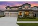 Beautiful two-story home with a three-car garage and a well-manicured lawn at 3559 Maple Bay Ln, Land O Lakes, FL 34638