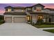Charming two-story home features a two-car garage and a beautifully landscaped front yard at 3559 Maple Bay Ln, Land O Lakes, FL 34638