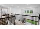 Bright hallway with iron railing offering views of the outdoors, enhancing the home's appeal at 3559 Maple Bay Ln, Land O Lakes, FL 34638