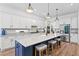 Bright kitchen features a large island with seating, stainless steel appliances, and ample counter space at 3559 Maple Bay Ln, Land O Lakes, FL 34638