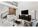 Spacious living room with modern design and a striking feature wall by the staircase at 3559 Maple Bay Ln, Land O Lakes, FL 34638